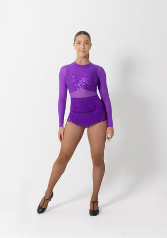 Adult dancer wearing a purple sequin leotard with mesh long sleeves and fringing, front view.